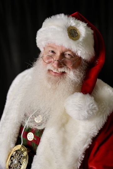 Santa Bear David smiling in his red and white Santa suit